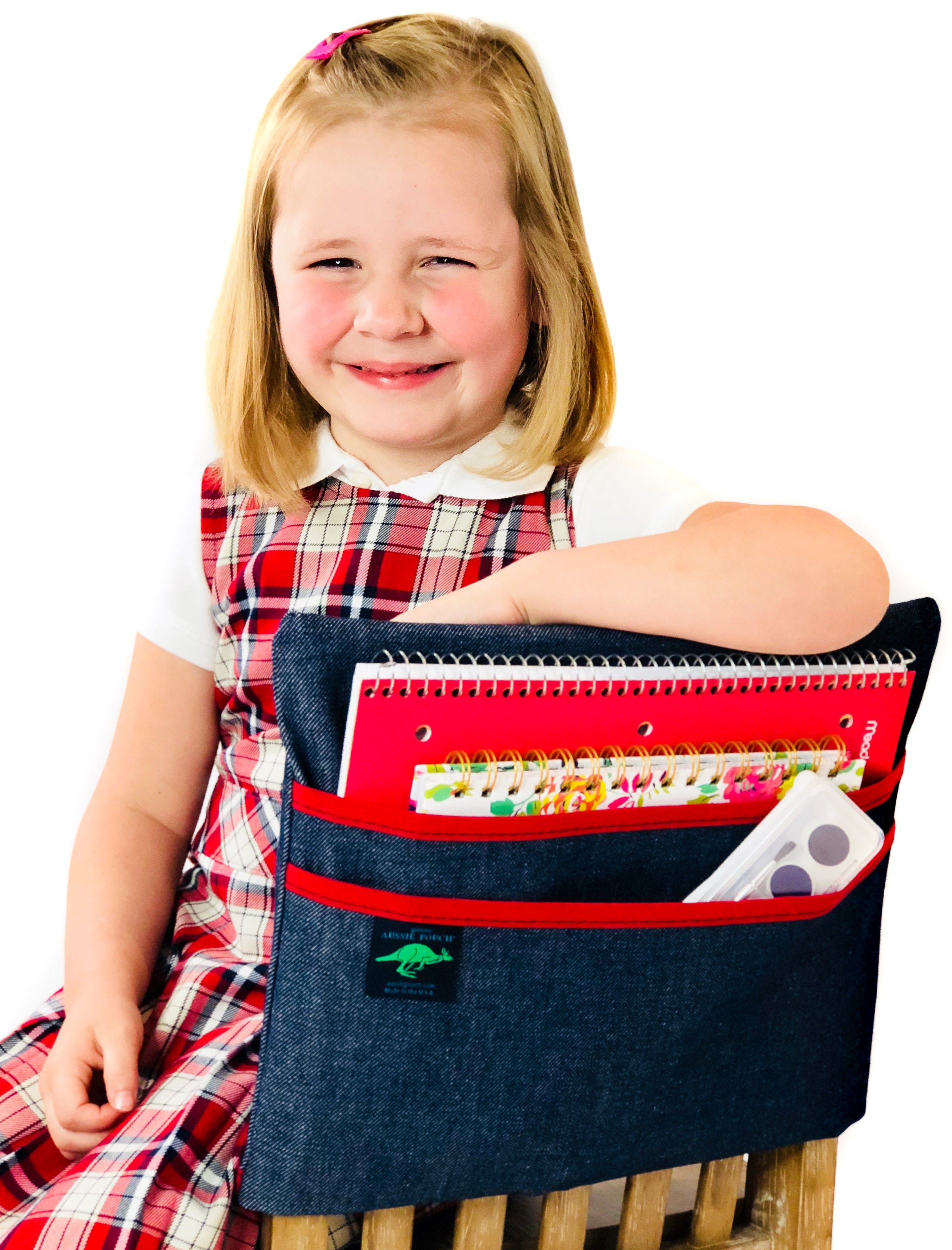 Girl using an Aussie Pouch Chair Pocket to store school supplies